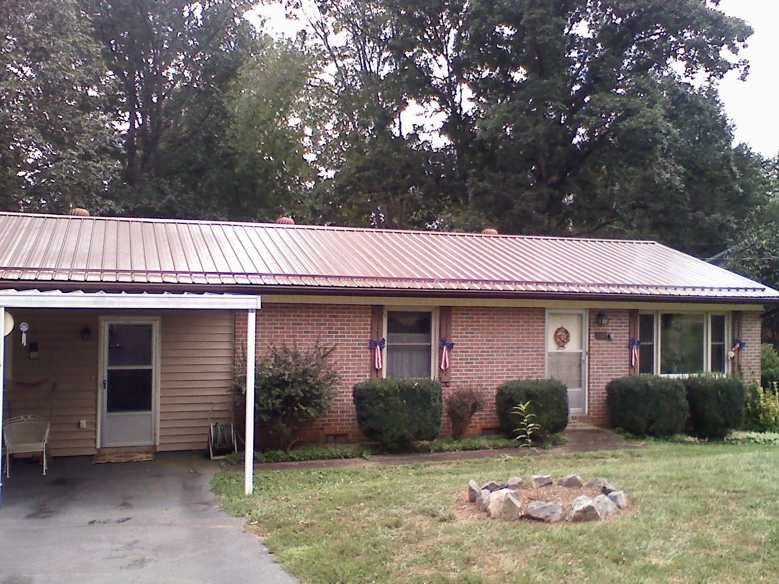 Bronze metal roof and carport on a brick ranch home — Roof Repair work by our crew in Maywood