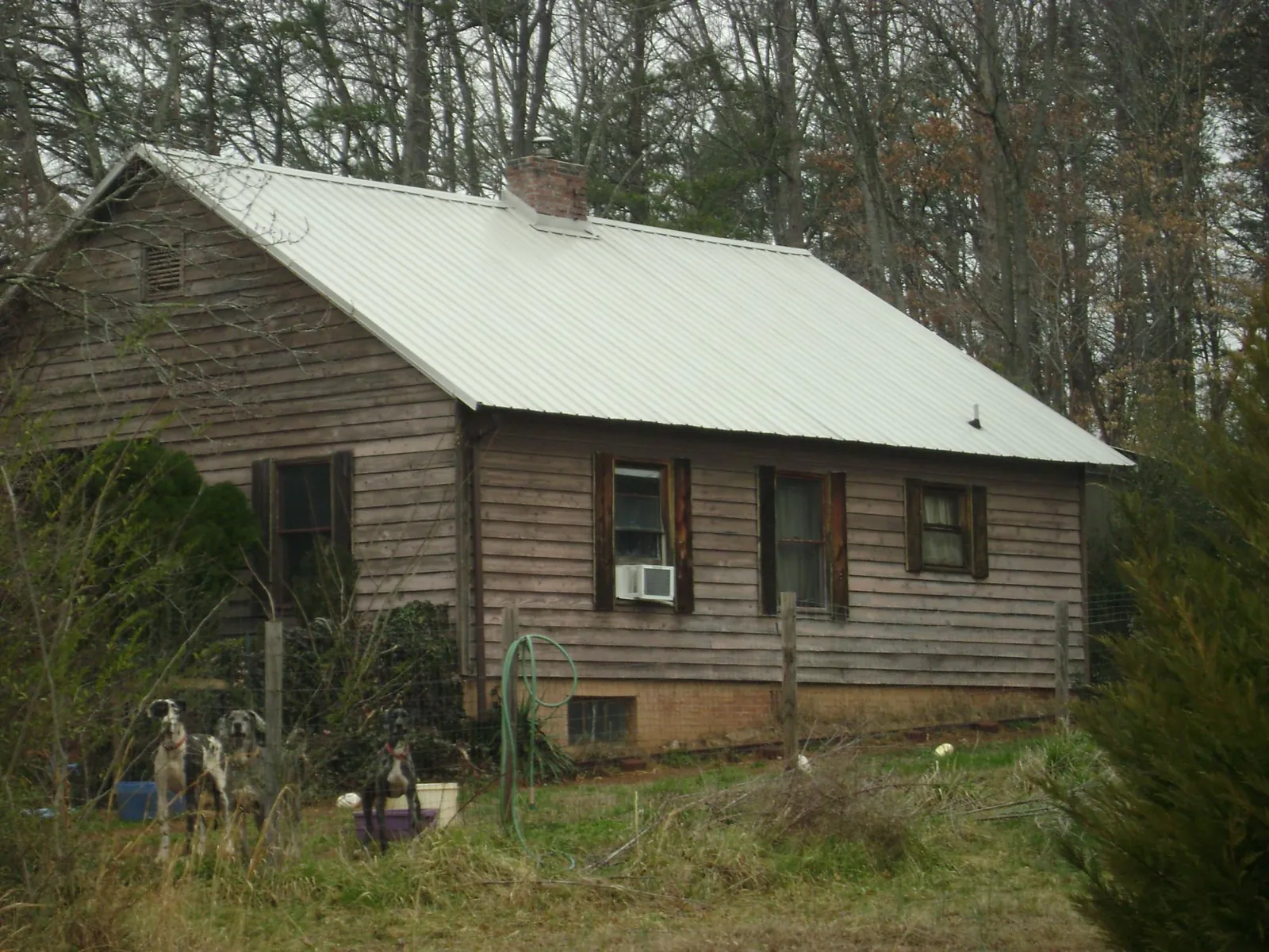 White metal roof on an old wood sided farmhouse, from a Metal Roof Installation job in Maywood